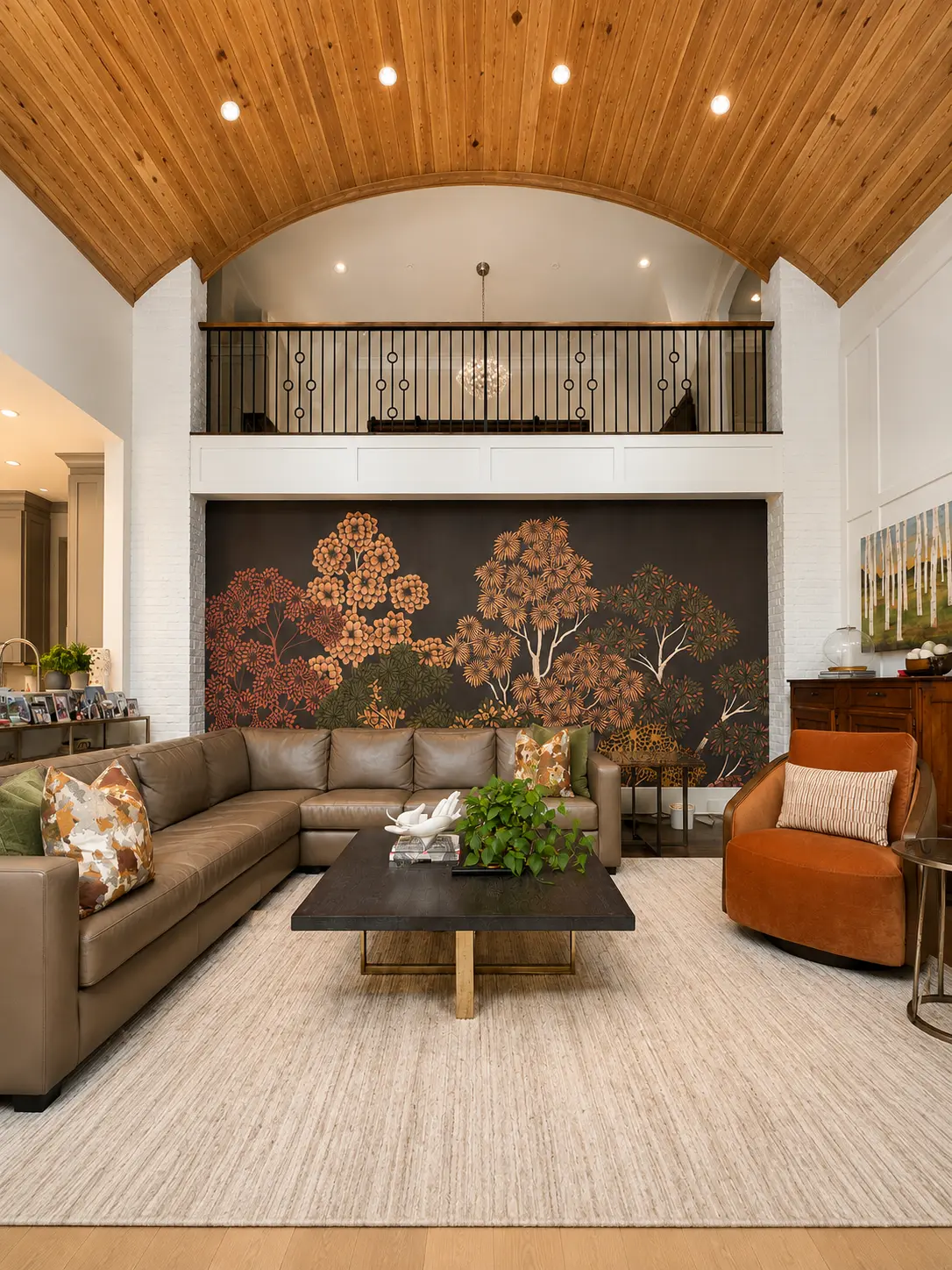 Dark botanical tree mural installation on a two-story living room wall in Atlanta, GA